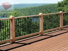 a wooden deck with metal railings overlooks a river and forested hills in the distance