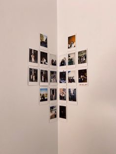 a white wall with multiple pictures hanging on it's sides and the bottom part of an open door