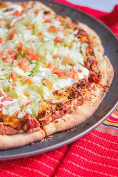 a pizza sitting on top of a pan covered in cheese and vegtables