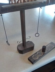 a pair of scissors sitting on top of a table next to a piece of wood