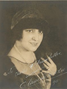 an old black and white photo of a woman wearing a hat with writing on it