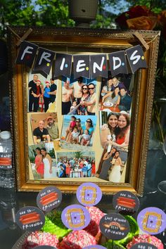 a table topped with pictures and cupcakes covered in frosting next to a framed photo