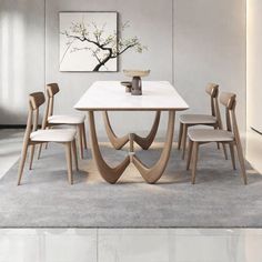 a white table with chairs around it in a room