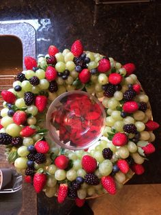 a wreath made out of grapes and strawberries