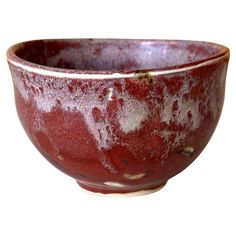 a red and white bowl sitting on top of a table