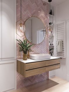 a bathroom with a sink, mirror and plants on the counter in front of it