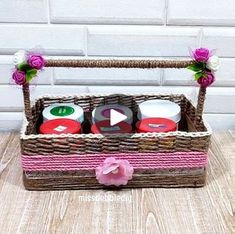 a wicker basket filled with candles and flowers