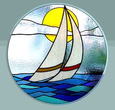 a round stained glass window with a sailboat in the ocean on it's side