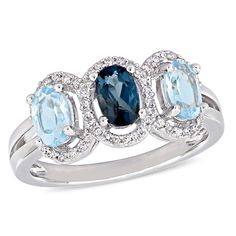 This 3-stone ring in sterling silver features 1 3/5ct oval cut london and sky blue topaz stones at its center surrounded by a total of 50 round cut prong set 1/5ct diamonds in a unique split shank halo design. Bold Rings, Blue Topaz Stone, Sterling Silver Engagement Rings, Sky Blue Topaz, Silver Engagement Rings, Topaz Stone, Elegant Ring, Blue Topaz Ring, London Blue Topaz