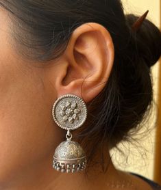 The Handmade Solid Silver Earrings you're describing are likely crafted from 925 sterling silver, which is a high-quality standard for silver jewelry, ensuring durability and a beautiful shine. These earrings seem to be in the traditional jhumka style, which is known for its elegant, bell-shaped design that often incorporates intricate detailing. The mention of "antique" suggests that the earrings have been oxidized or treated to give them a vintage appearance, adding to their charm and making them stand out as a piece of traditional silver jewelry. Being handmade, they would exhibit unique craftsmanship, with each piece carrying its own subtle differences. These earrings would be perfect for someone who appreciates traditional, handcrafted jewelry with a timeless appeal. Are you looking t Antic Silver Earrings, Handmade Silver Fusion Style Jhumkas, Handmade Silver Fusion Jhumkas, Silver Fusion Style Drop Jhumkas, Heavy Sterling Silver Drop Earrings, Traditional Silver Earrings With Tilla, Traditional Silver Tilla Earrings, Silver Hallmarked Fusion Jhumkas, Heavy Sterling Silver Dangle Earrings