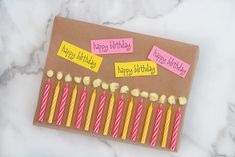 a birthday card with candles on it and sticky notes attached to the top of them