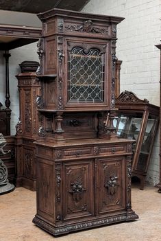 an old fashioned wooden cabinet sitting in a room