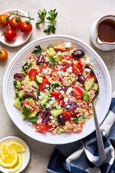 a salad with tomatoes, cucumber, olives, and feta cheese