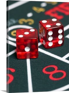 two red dice sitting on top of a black table