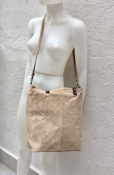 Tote suede leather bag in LIGHT BEIGE. Natural genuine suede leather. Beige large shoulder or cross body bag.Closed by a zipper, with shoulder straps in brown grain leather and removable longer adjustable straps in suede. The inside of the bag is lined in a cotton/nylon strong fabric. Zipper closed pocket and pouch for your cellular phone inside. . You can easily carry your books, laptop or tablet in one nice bag, wear it with the shorter leather straps as a shoulder bag or cross body with the l Everyday Suede Shoulder Bag With Adjustable Strap, Beige Leather Bags With Suede Lining, Suede Shoulder Bag With Adjustable Strap For Daily Use, Everyday Suede Soft Leather Shoulder Bag, Soft Suede Leather Crossbody Shoulder Bag, Soft Suede Crossbody Shoulder Bag, Chic Beige Suede Shoulder Bag, Rectangular Suede Shoulder Bag With Soft Leather, Everyday Suede Tote Shoulder Bag