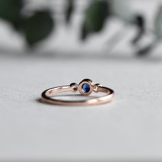 Genuine sapphire-adorned three stone ring. 14k Rose gold fully hallmarked 3mm blue Sapphire center stone. 1.75mm White Sapphires Approx 1.5mm band width FREE SHIPPING USA- All of our jewelry will arrive in custom packaging ready for gift giving. LEAD TIME: Made to order will take 10-14 days. Signature upon delivery, we unfortunately will not be able to reimburse or replace lost or stolen shipments. FOLLOW US ON: Instagram: @roseandchoc Facebook: /Roseandchoc Pinterest: @Roseandchoc Rose Gold Round Cut Sapphire Ring, Rose Gold Sapphire Ring With Round Cut, Dainty Rose Gold Sapphire Birthstone Ring, Rose Gold Stackable Sapphire Ring, Stackable Rose Gold Sapphire Ring, 14k Rose Gold Sapphire Promise Ring, Rose Gold Sapphire Ring With Gemstone, Minimalist Rose Gold Sapphire Ring Birthstone, Rose Gold Sapphire Ring With Round Band