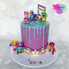 a birthday cake decorated with characters and icing