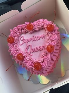 a pink heart shaped cake with cherries in it's center and the words cupcake queen written on top