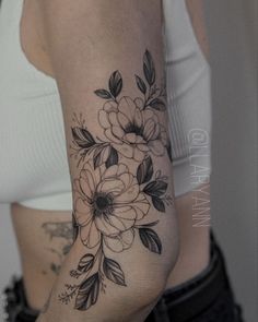 a woman's arm with flowers on it