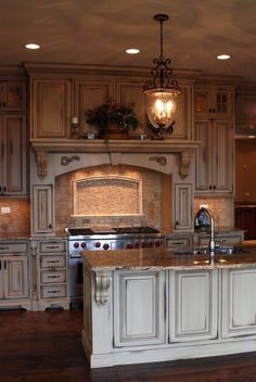 a large kitchen with an island in the middle and lots of cabinets on both sides