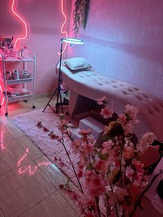 a room with pink lighting and flowers on the floor