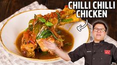 a man holding up a plate with food in it and the words chilli chilli chicken above it