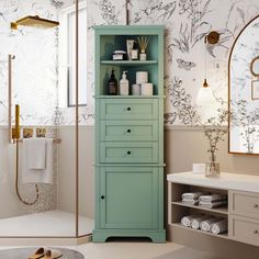 a bathroom with a green cabinet in the middle and white towels on the shelf next to it