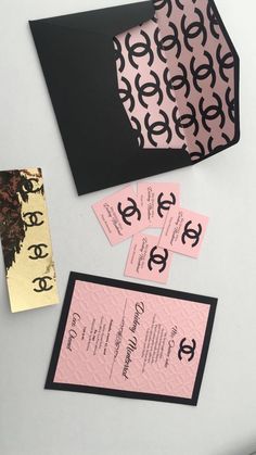 some pink and black cards are on a table