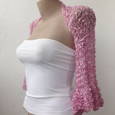 This Pink Ruffle Sleeves Silky Bolero is a perfect accessory for your summer outfit. It gives an elegant silky touch and is proper for the late spring and the summer months. Be the star at the dancing with this lightweight loose shrug. It matches perfectly with an evening dress as well over a party top.   This bolero is quite stretchy. Ask for a Custom order to fit exactly your size ot choose it according to the measures given below. It is available in Plus size also. Please contact us to send u Feminine Crochet Top For Spring Party, Summer Party Shrug With Stretch, Stretch Summer Party Shrug, Elegant Fitted Summer Shrug, Spring Party Lace Shrug, Spring Party Crochet Top, Elegant Stretch Shrug For Spring, Elegant Summer Crochet Top, Spring Party Long Sleeve Crochet Top