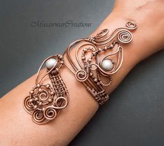 "Unique and original design of bracelet cuff. This is a very stylish bracelet and can be worn with any kind of outfit. This bracelet is carefully handcrafted made out of thick pure copper wire and wrapped with silver pearls 9mm. Bracelet is adjust size up to diameter minimum 2.5\" to ,2.7\" maximum . Bracelet is easily adjusted with light pressure to custom fit your wrist. Your bracelet will arrive well packed inside a box with padded envelope. If you have any questions about it, please do not h Elegant Silver-colored Copper Bracelets, Elegant Silver-colored Copper Cuff Bracelet, Elegant Handmade Copper Bracelets, Elegant Wire Wrapped Copper Cuff Bracelet, Elegant Copper Wire Wrapped Cuff Bracelet, Elegant Copper Bracelets As Gift, Elegant Copper Wire Wrapped Bracelets, Elegant Copper Bracelet As A Gift, Elegant Copper Bracelets For Gift