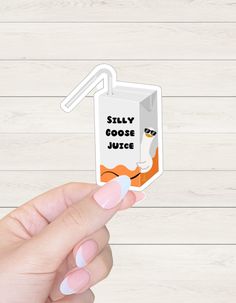 someone is holding up a sticker with the words silly goose juice on it,