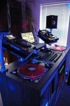 a dj's desk with two turntables and a laptop