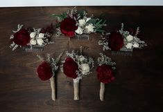 six hair combs with flowers and greenery on top of a wooden table next to each other