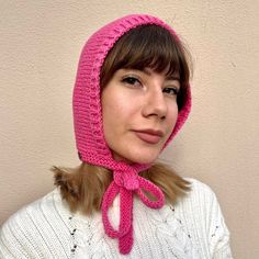 a woman wearing a pink hat and scarf