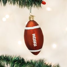 an ornament hanging from a christmas tree with a football on it's side