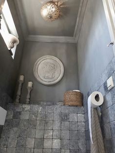 an overhead view of a bathroom with gray walls and tile flooring, including a toilet