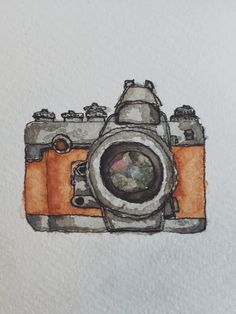 a drawing of an orange camera on white paper