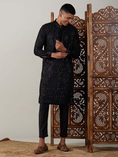 Vastramay Men's Black Mirror Georgette Kurta Pant Set A classic blend of tradition and style, this Black Mirror Georgette Kurta Pant Set from Vastramay is perfect for special occasions. The kurta features intricate mirror work on the collar and cuffs, adding a touch of elegance. The set includes a matching pant for a complete look. Features: Elegant mirror work on collar and cuffs Comfortable and stylish Perfect for special occasions Specifications: Brand: VASTRAMAY Color: Black Material: George Black Sherwani For Winter, Elegant Black Kurta For Celebration, Black Traditional Wear For Festive Semi-formal Occasions, Black Semi-formal Traditional Wear For Festive Occasions, Traditional Fitted Pants For Festive Occasions, Black Traditional Wear For Winter Ceremonial, Black Traditional Wear For Ceremonial Winter Events, Black Long Sleeve Sherwani For Traditional Ceremonies, Long Sleeve Black Sherwani For Traditional Ceremonies