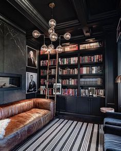 a living room filled with furniture and bookshelves covered in lots of bookcases