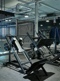 an empty gym with equipment in the middle and lights above it, all lit up