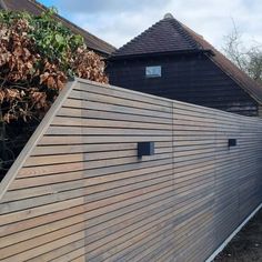 a large wooden fence next to a house