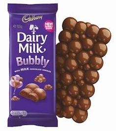 a chocolate bar next to a bag of milk caramel covered candy balls on a white background