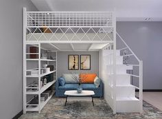 a living room with a blue couch under a loft bed next to a stair case