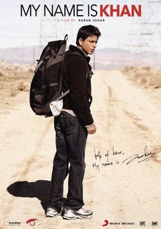 a man standing in the middle of a dirt road with a backpack on his back