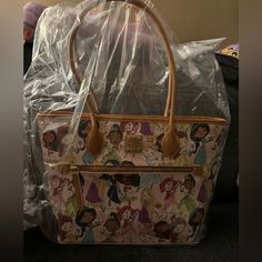 This Nwt Dooney & Bourke Disney's "Animators Multi Princess" Tote Bag Is Perfect For All Disney Princess Enthusiasts. The Large Size Is Ideal For Carrying All Your Essentials, While The Multicolor Design Adds A Touch Of Fun To Your Look. Trim: 100% Leather (12" - 15") W X 10'' H X 5 1/2'' D, Strap Drop Length: 10'' Disney Shopping Bags, Woven Leather Tote, Dooney And Bourke Disney, All Disney Princesses, Dooney & Bourke Bag, Tote Outfit, Large Leather Tote Bag, Denim Shoulder Bags, Blue Handbags