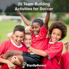 a group of young children standing next to each other on top of a soccer field