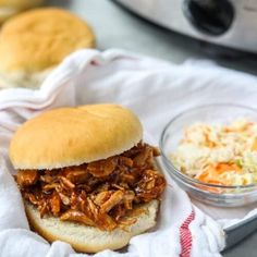 pulled pork sandwich with coleslaw and carrots on the side next to an instant pressure cooker