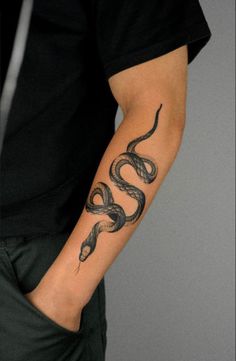 a man with a snake tattoo on his arm