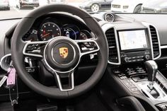 the interior of a porsche car with dashboard and steering wheel controls, including an electronic display