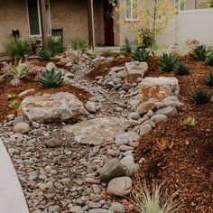 a rock garden bed in front of a house